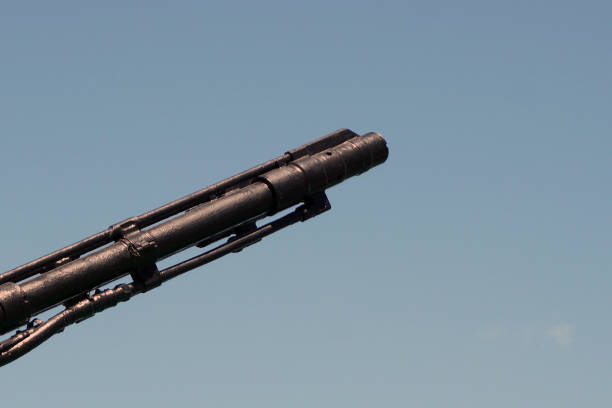 Muzzle barrel of naval ship artillery gun on a blue sky background. copy space, selective focus, narrow depth of field