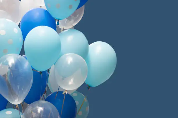 Photo of colorful balloons on blue background. happy new year and happy birthday concept