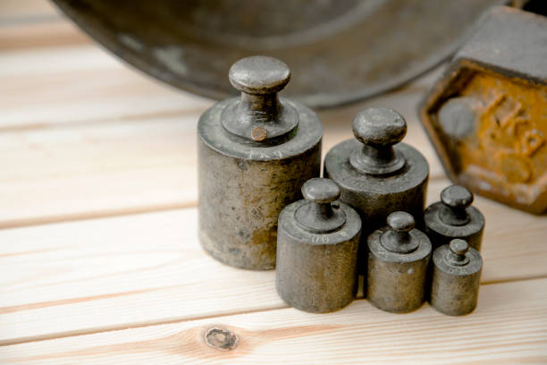 Old rusty scale weight on wooden table, Old rusty iron scale weight