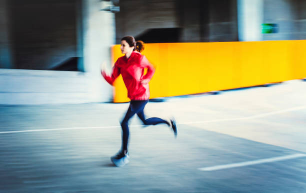 istock Young Woman Running in an Urban Environment, Blurred motion 1131782980