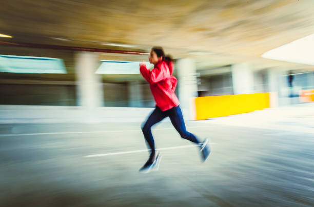 istock Young Woman Running in an Urban Environment, Blurred motion 1131782997