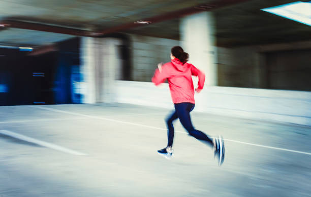 istock Young Woman Running in an Urban Environment, Blurred motion 1131782999
