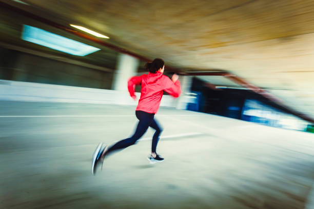 istock Young Woman Running in an Urban Environment, Blurred motion 1131783008