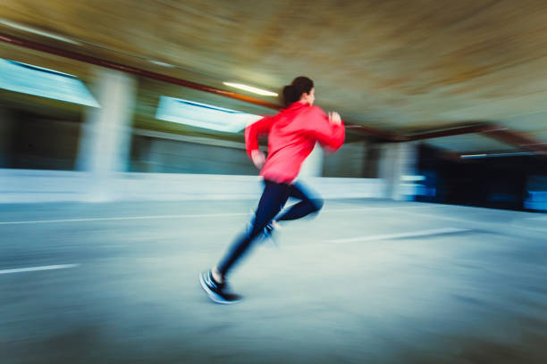 istock Young Woman Running in an Urban Environment, Blurred motion 1131783032