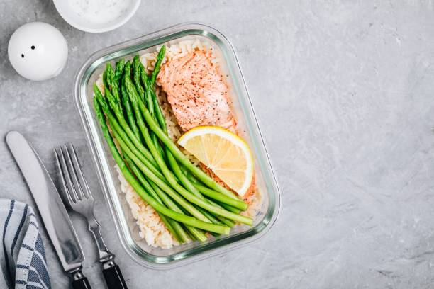 istock Meal prep lunch box container with baked salmon fish, rice, green asparagus 1131783255