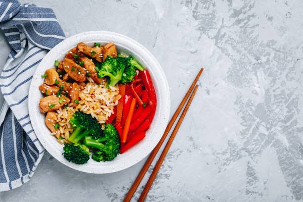 teriyaki chicken buddha bowl lunch with rice, broccoli and red bell pepper - healthy eating food rice high angle view imagens e fotografias de stock