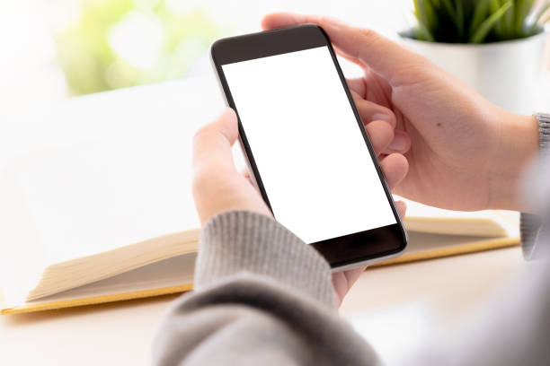 istock Close up Woman hand Using a Smart Phone with blank screen at home. 1131784442