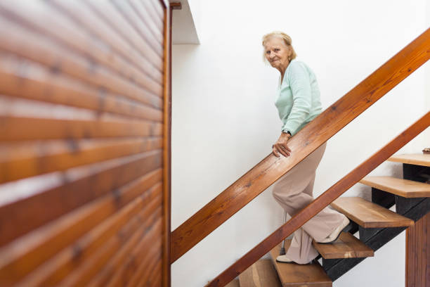 istock Elderly woman at home using a cane to get down the stairs 1131785538