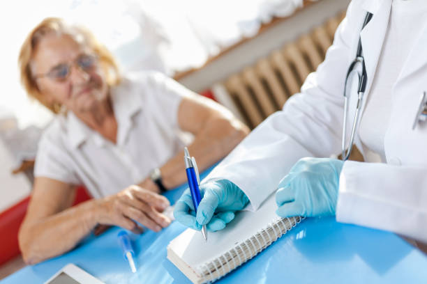 istock Senior woman during a medical exam with practitioner 1131785652