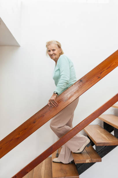 istock Elderly woman at home using a cane to get down the stairs 1131786978