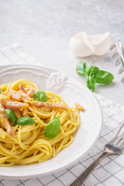 istock Italian pasta carbonara with ham, basil and eggs. 1131787274