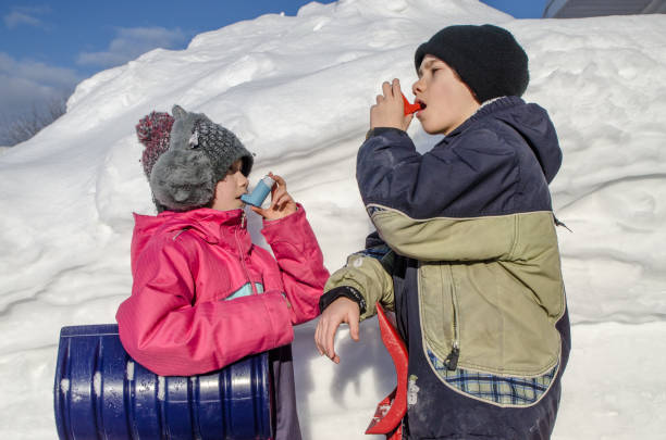 istock Young boy and girl using asthma pump after snow shoveling 1131788720