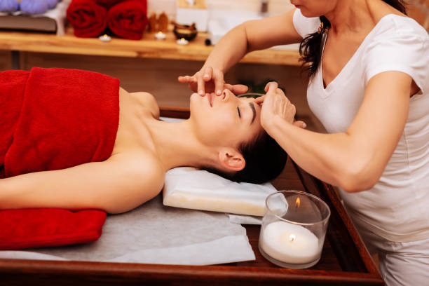 istock Active master in white t-shirt touching flawless skin of her client 1131793078