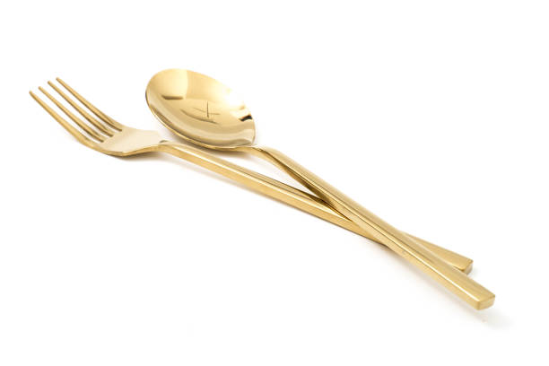 istock golden spoon and fork isolated on a white background 1131793359