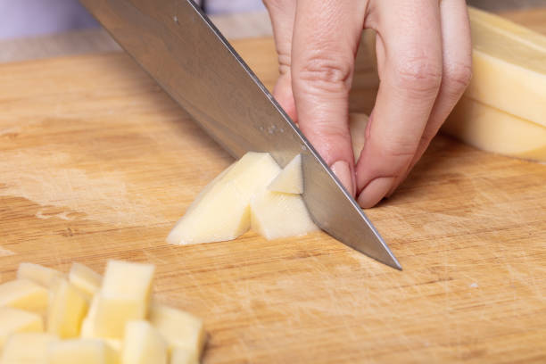 istock cook cuts potatoes on a wooden board 1131796061