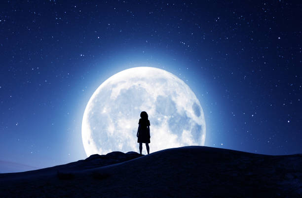 Girl looking at the moon stock photo