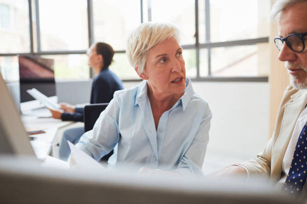 istock Two business people having a  meeting in the office. 1131797671