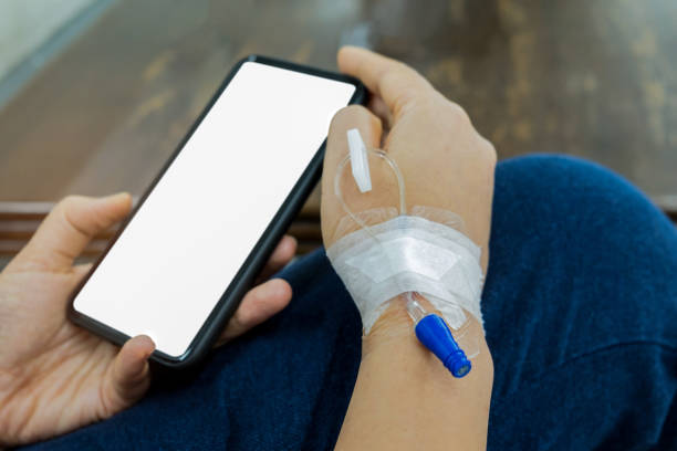 istock Patients with needle fill in saline arm.Playing blank screen mobile phone waiting for treatment. 1131799950