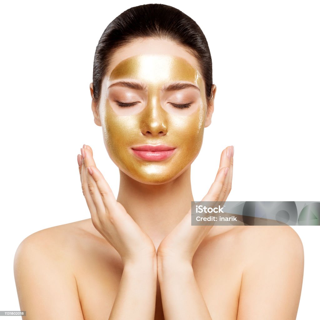 Woman Gold Mask, Beautiful Model with Golden Skin Cosmetic, Beauty Skincare and Treatment Woman Gold Mask, Beautiful Model with Golden Skin Cosmetic, Beauty Skincare and Treatment, Shot over white studio background Gold - Metal Stock Photo