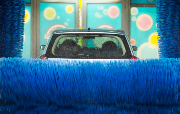 Car wash, in automatic car wash, rotating red and blue brushe. Washing vehicle.