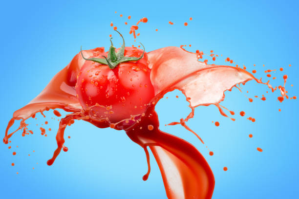 istock tomato in juice splash on a blue background 1131803507