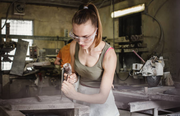 istock Young Woman Engraving to Stone 1131804243