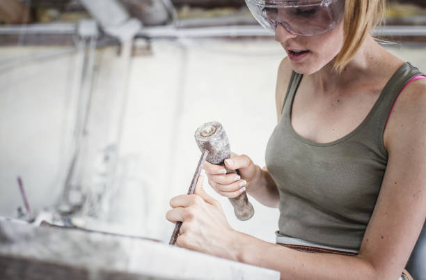 istock Young Woman Engraving to Stone 1131804279