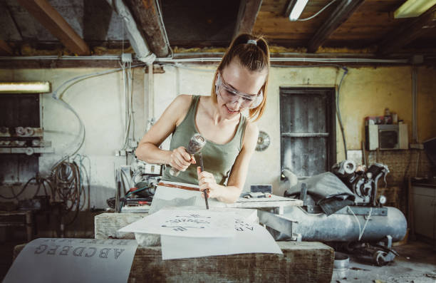 istock Young Woman Engraving to Stone 1131804363