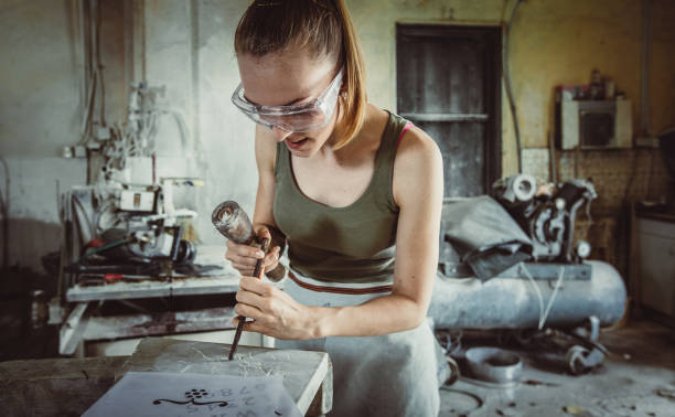 istock Young Woman Engraving to Stone 1131804364