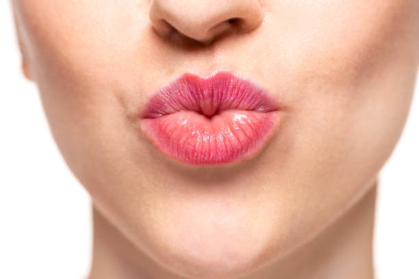 istock Woman's lips with pink lipstick and kiss gesture 1131804800
