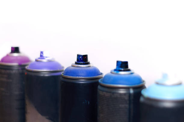 istock blue and violet spray cans on graffiti on an isolated white background close-up 1131807999