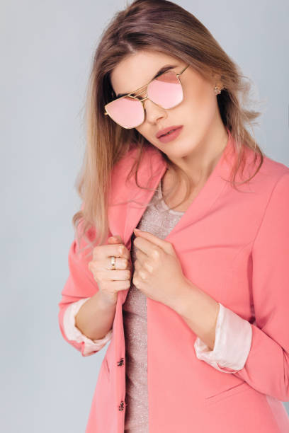 istock blonde woman in pastel casual jacket posing in studio. 1131809369