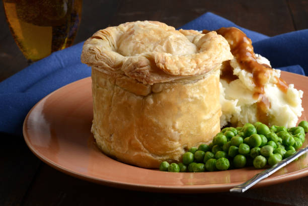 istock closeup pub meat pie with mashed potatoes and peas 1131810613