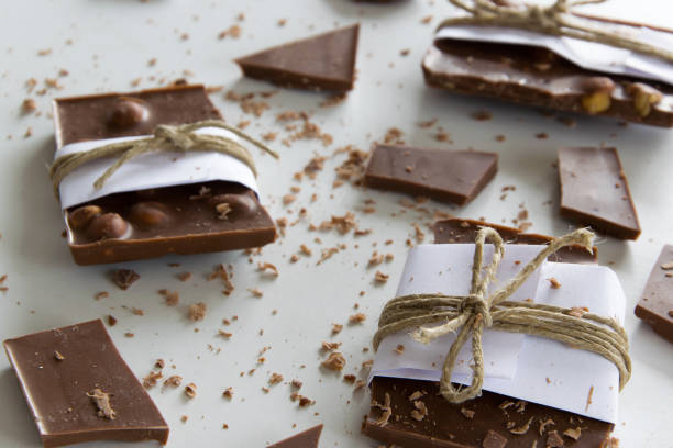 istock Broken chocolate pieces on white background, delicious sweet snack background 1131811023
