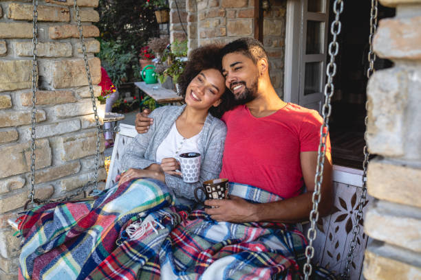 istock Relaxing couple enjoying tea on a porch swing 1131811074