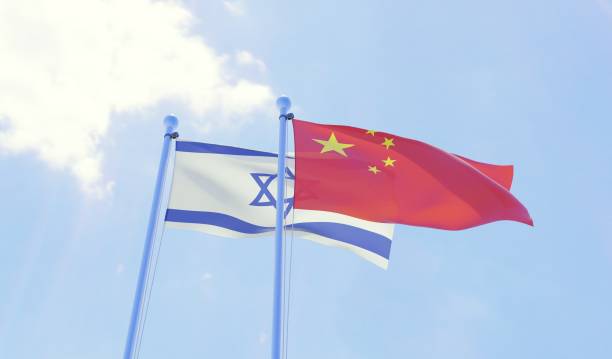 istock Israel and China, two flags waving against blue sky 1131811876