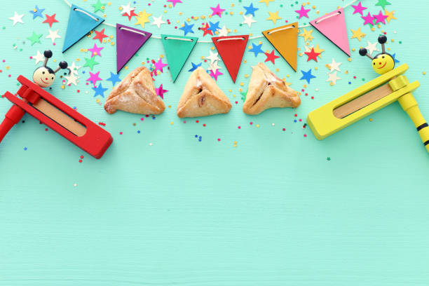 istock Purim celebration concept (jewish carnival holiday) over wooden mint background 1131812017