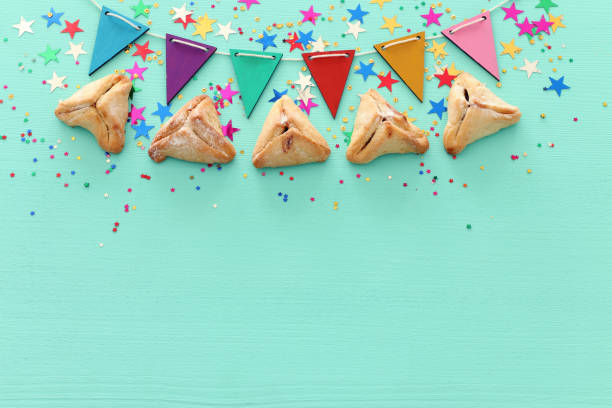istock Purim celebration concept (jewish carnival holiday) over wooden mint background 1131812026