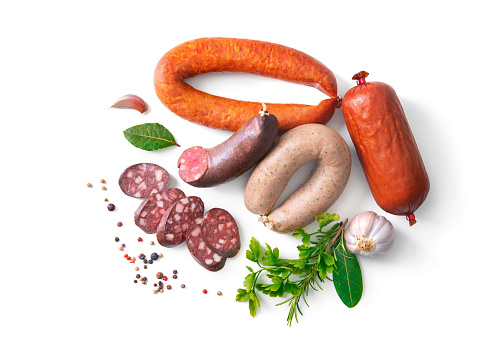 Assortment of german homemade sausage specialties: hard cured salami, liver sausage (Leberwurst), blood sausage (Blutwurst) and salami isolated on white