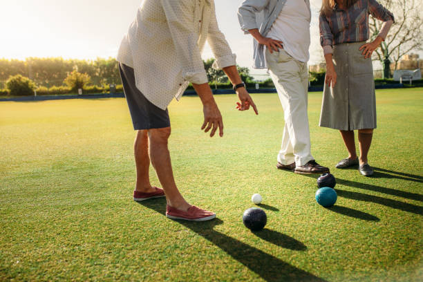 istock Group of people playing boules in a lawn 1131812497