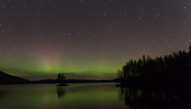 istock Northern lights, Aurora borealis over a lake 1131813783