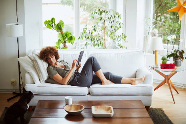 istock One woman relaxing and reading at home. 1131816585