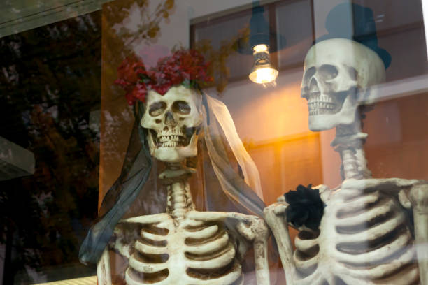 istock Two dressed up for honeymooners skeletons on the window. 1131816709