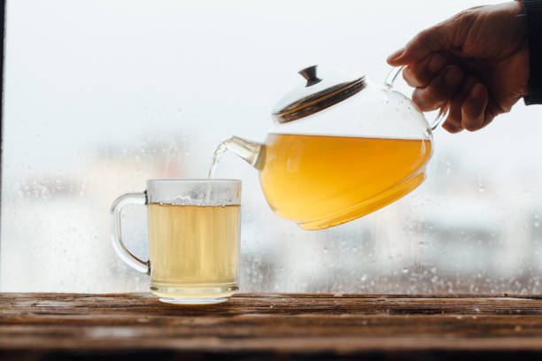 istock Senior men pouring green tea beside window 1131817091