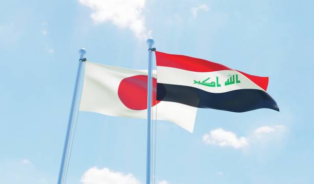 istock Iraq and Japan, two flags waving against blue sky 1131818681