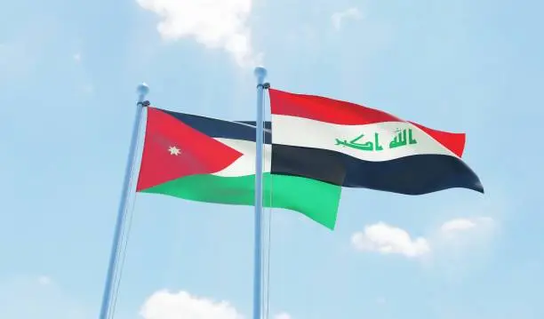 Iraq and Jordan, two flags waving against blue sky. 3d image