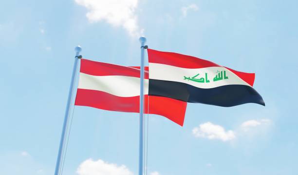 istock Iraq and Austria, two flags waving against blue sky 1131819929