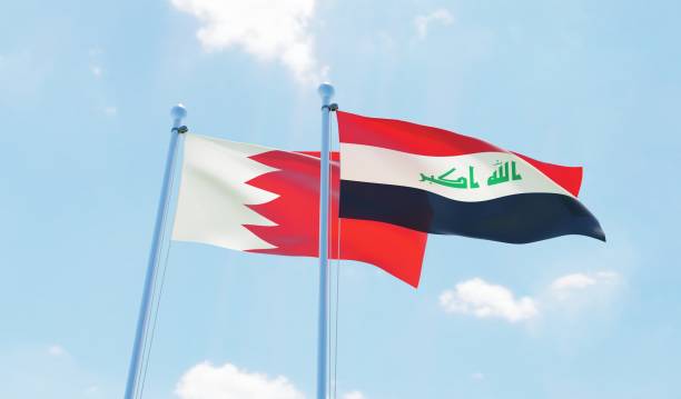 istock Iraq and Bahrain, two flags waving against blue sky 1131819940