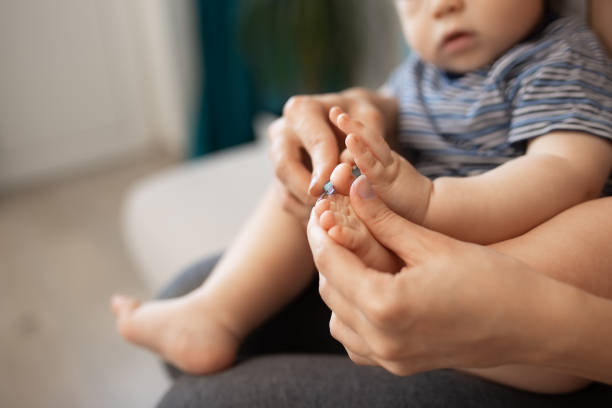 istock mother cutting nails for baby 1131822885