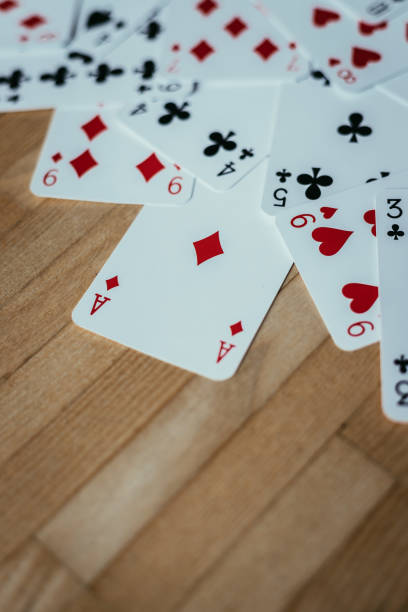Cards lying on rustic wood table, playing cards. Copy space.